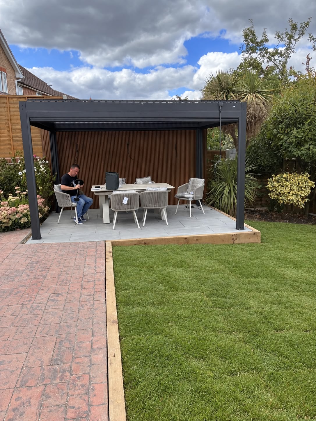Pergola installation with timber edging and manicured lawn